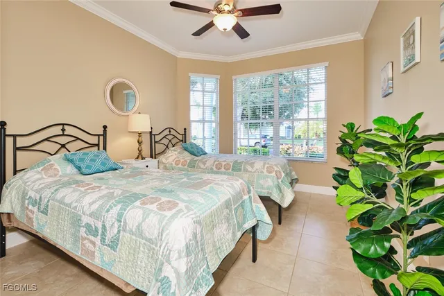 a bedroom with bed and a large window