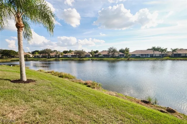 a view of a lake with houses in the back