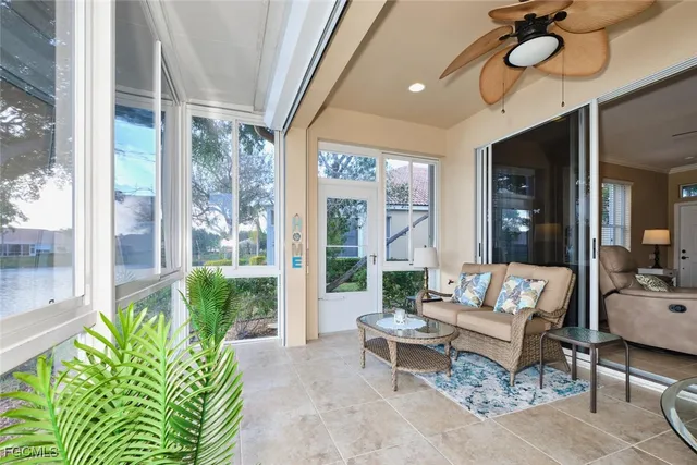 a living room with patio furniture and a potted plant