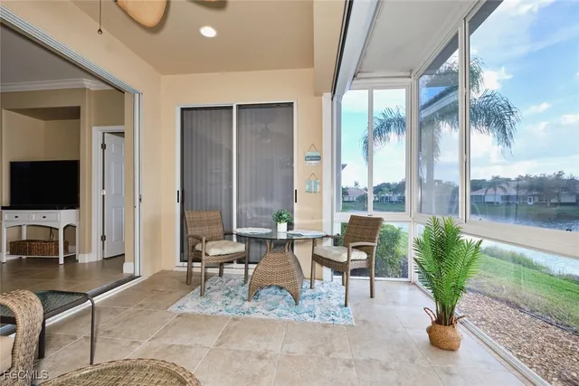 a living room with patio furniture and a flat screen tv