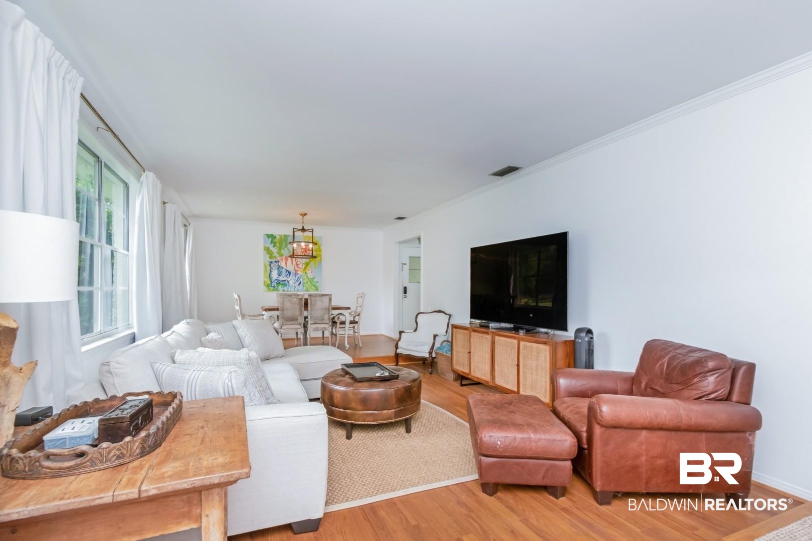 4596 Hawthorne Place Mobile, AL 36608 - Photo 2 of 34 Spacious living area featuring wood-finish flooring, white walls, and crown molding