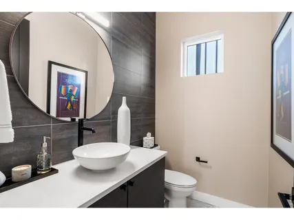 a bathroom with a sink and a mirror with toilet