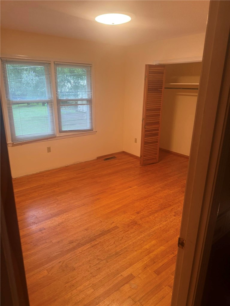 4027 Belhaven Road Belton, SC 29627 - Photo 11 of 24 Well-lit sleeping quarters with rich hardwood flooring and a functional closet.