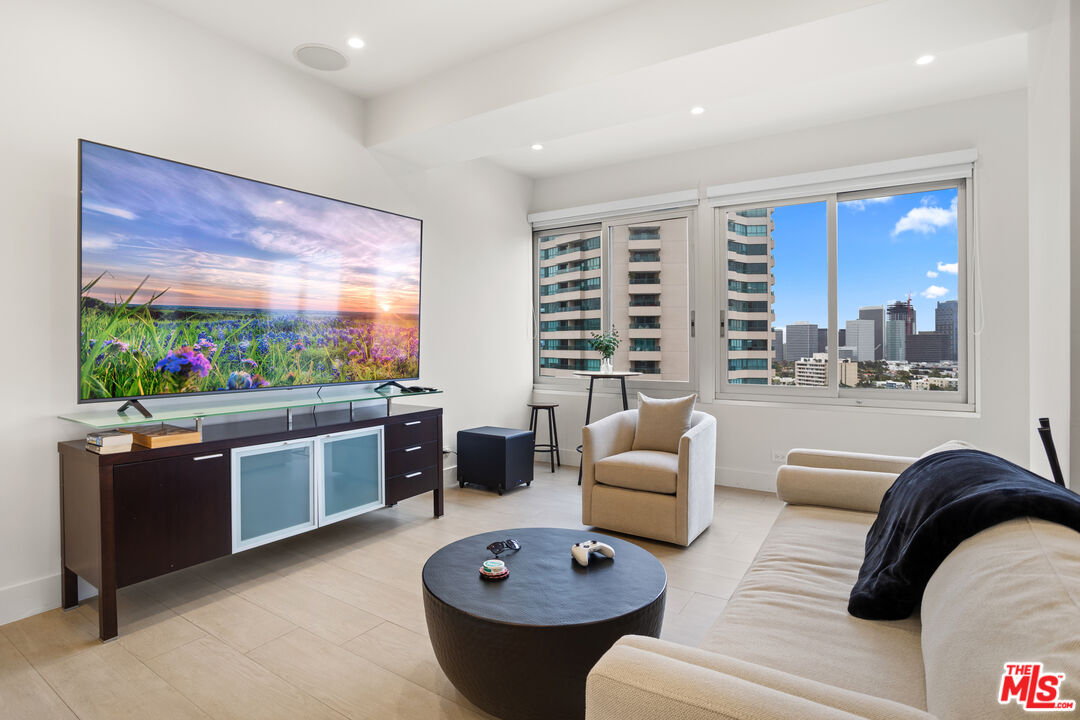 10501 Wilshire Boulevard, Unit 1605 Los Angeles, CA 90024 - Photo 1 of 27 a living room with furniture a window and a dining table with garden view