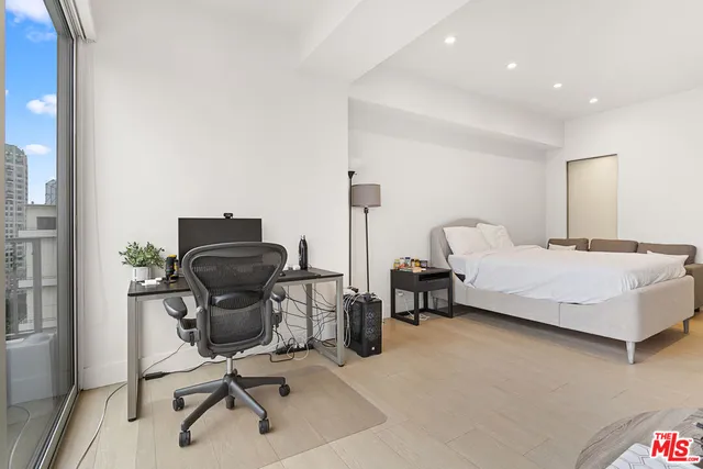 a bedroom with a bed a desk and chair