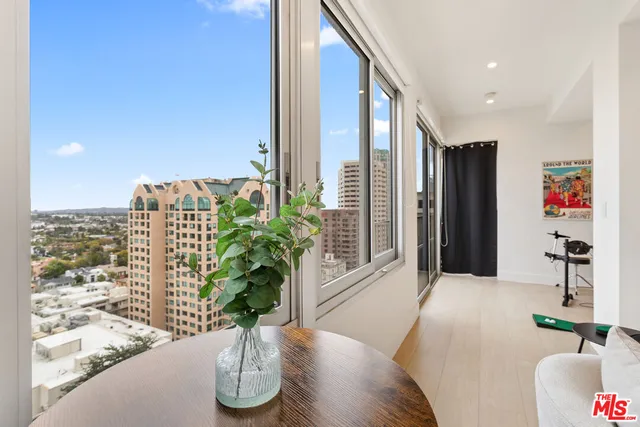 a vase of flowers sitting on a table with wooden floor