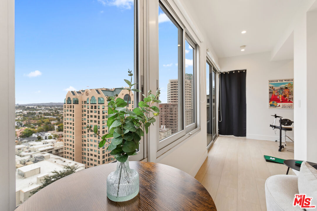 10501 Wilshire Boulevard, Unit 1605 Los Angeles, CA 90024 - Photo 17 of 27 a vase of flowers sitting on a table with wooden floor
