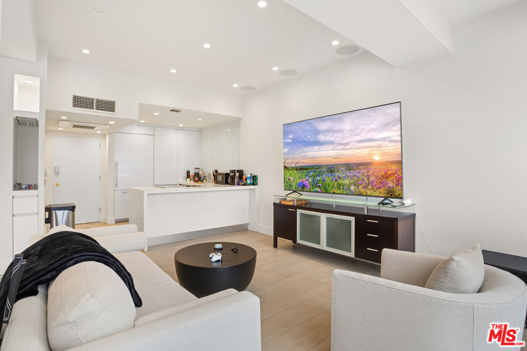 10501 Wilshire Boulevard, Unit 1605 Los Angeles, CA 90024 - Photo 19 of 27 a living room with furniture and a flat screen tv