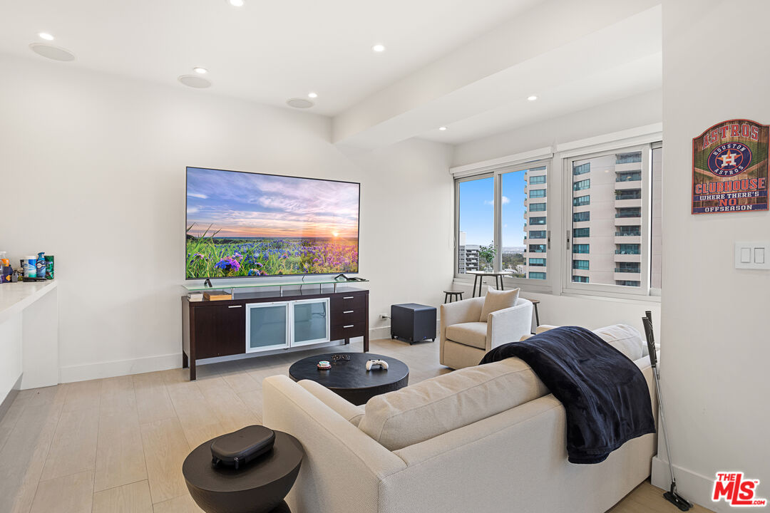 10501 Wilshire Boulevard, Unit 1605 Los Angeles, CA 90024 - Photo 20 of 27 a living room with furniture and a flat screen tv