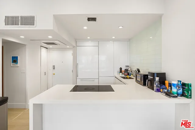 a kitchen with a sink and a refrigerator