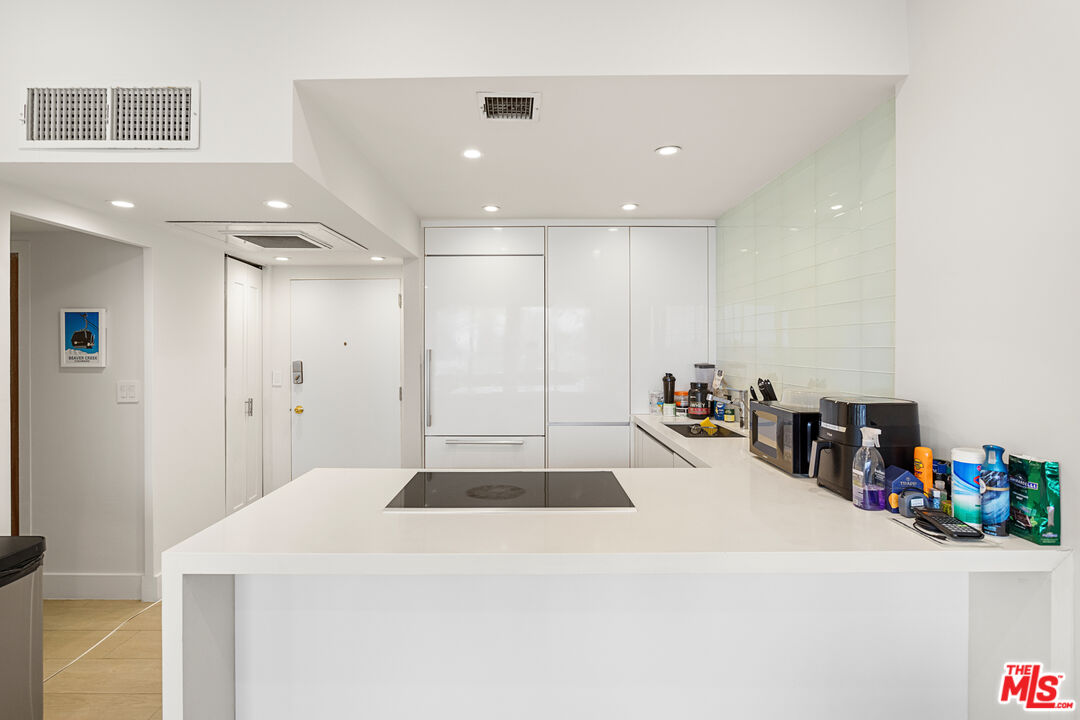 10501 Wilshire Boulevard, Unit 1605 Los Angeles, CA 90024 - Photo 22 of 27 a kitchen with a sink and a refrigerator