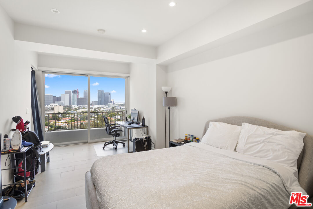 10501 Wilshire Boulevard, Unit 1605 Los Angeles, CA 90024 - Photo 8 of 27 a bedroom with a bed and a large window