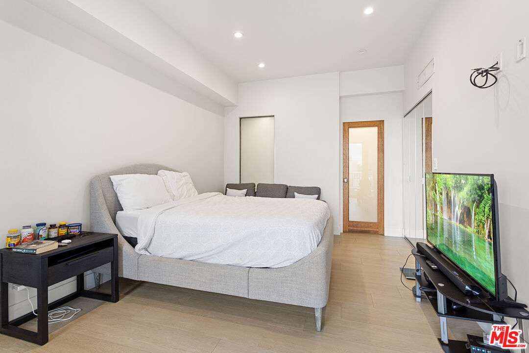 10501 Wilshire Boulevard, Unit 1605 Los Angeles, CA 90024 - Photo 9 of 27 a bedroom with a bed and a flat screen tv