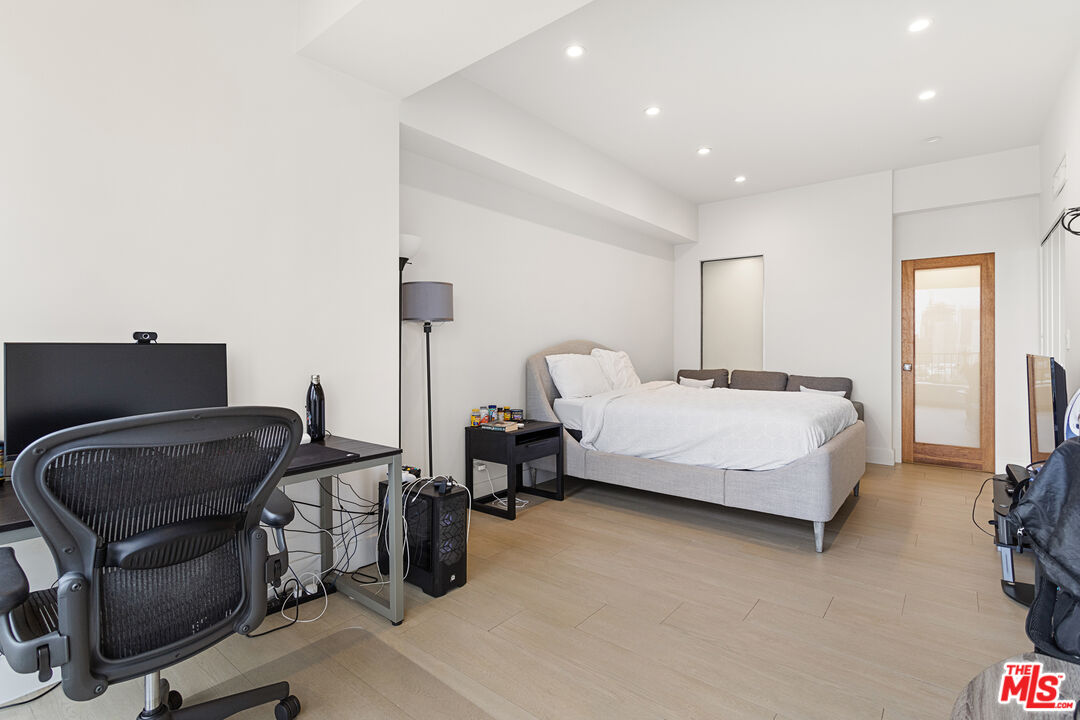 10501 Wilshire Boulevard, Unit 1605 Los Angeles, CA 90024 - Photo 10 of 27 a bedroom with a bed and with chair