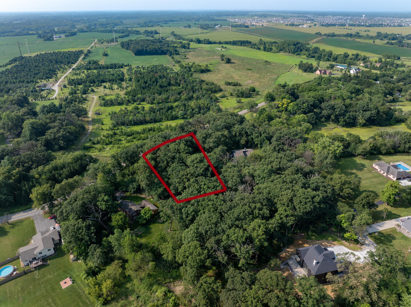 6308 West 91st Avenue Crown Point, IN 46307 - Photo 11 of 16 an aerial view of a houses with a lush green hillside