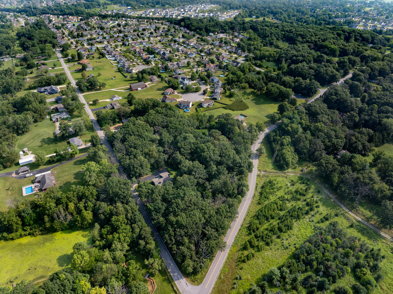 6308 West 91st Avenue Crown Point, IN 46307 - Photo 12 of 16 an aerial view of residential house with outdoor space and trees all around