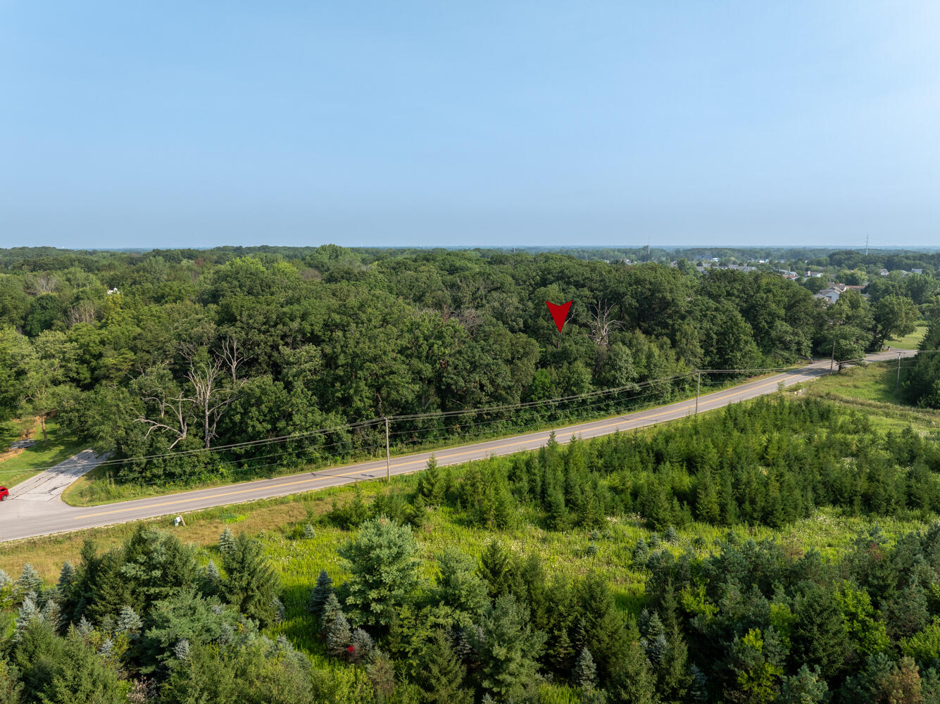 6308 West 91st Avenue Crown Point, IN 46307 - Photo 2 of 16 a view of a green field with lots of bushes