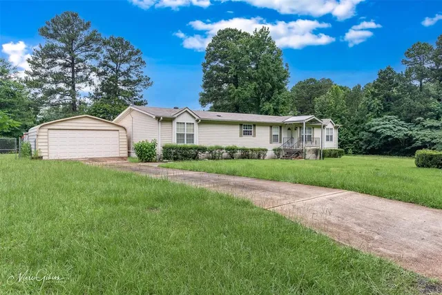 a house with green field in front of it