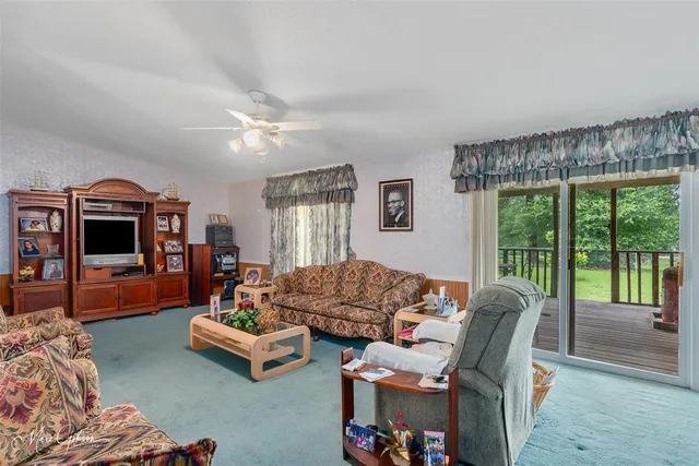 a living room with furniture and a floor to ceiling window