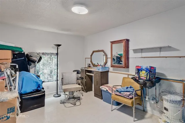 a living room with furniture a rug and gym equipment