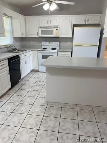 a view of empty room with a fireplace and wooden floor