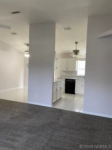 a view of a livingroom with an empty space and a window