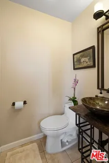 a white toilet sitting next to a bathroom sink