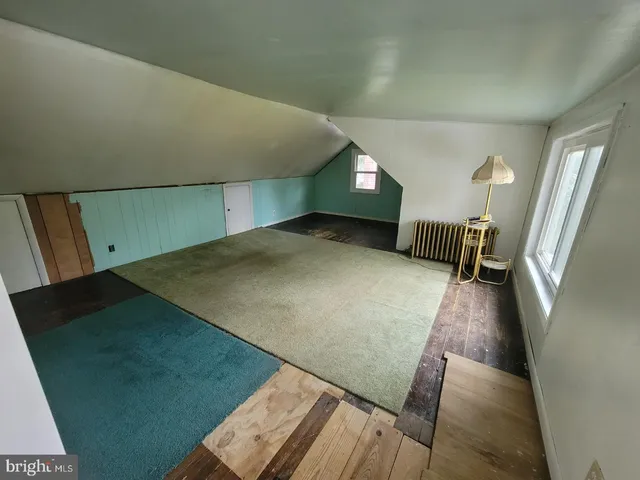 a view of a hardwood floor and staircase