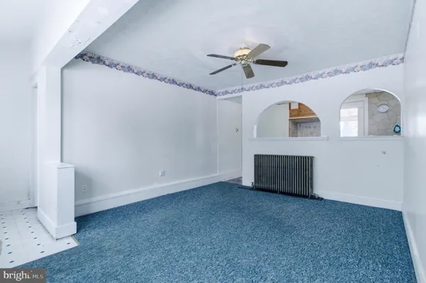 a view of a livingroom with a ceiling fan and window