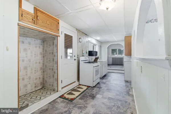 a view of a kitchen with refrigerator and windows