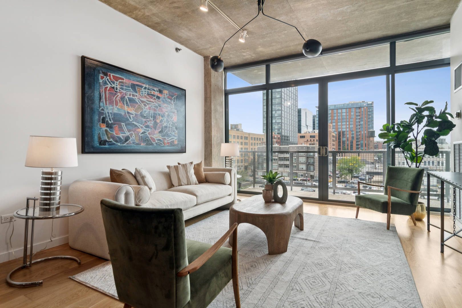 321 South Sangamon Street, Unit 501 Chicago, IL 60607 - Photo 2 of 11 a living room with furniture a chandelier and a floor to ceiling window