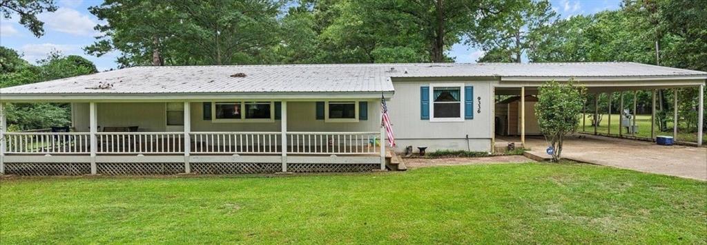 9336 Dean Road Shreveport, LA 71118 - Photo 1 of 25 Ranch-style house with a front yard, a carport, a porch, and view of scattered trees