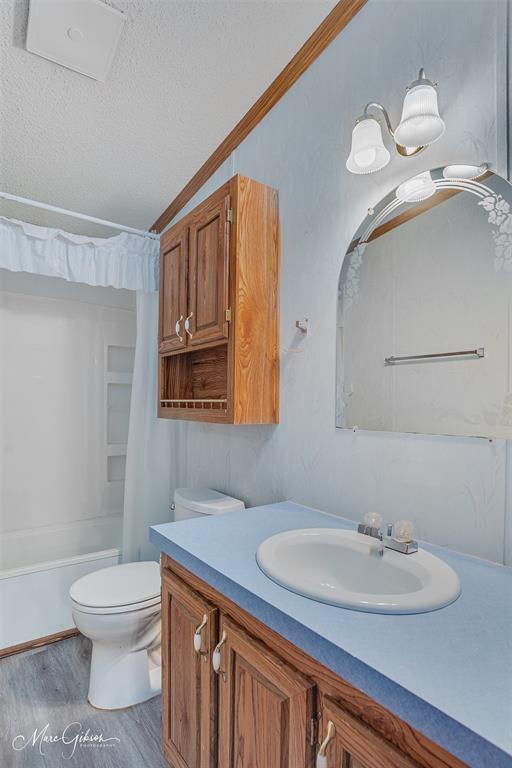 9336 Dean Road Shreveport, LA 71118 - Photo 24 of 25 textured ceiling, light wood-style flooring, crown molding, and cabinet space
