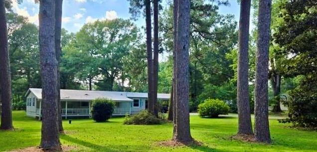 9336 Dean Road Shreveport, LA 71118 - Photo 5 of 25 View of grassy yard with view of scattered trees
