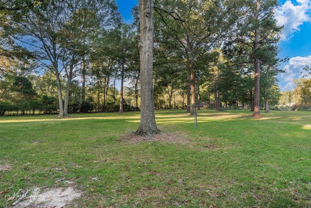 9336 Dean Road Shreveport, LA 71118 - Photo 9 of 25 Full bath featuring two vanities, a bath, ornamental molding, a textured ceiling, and light wood-type flooring