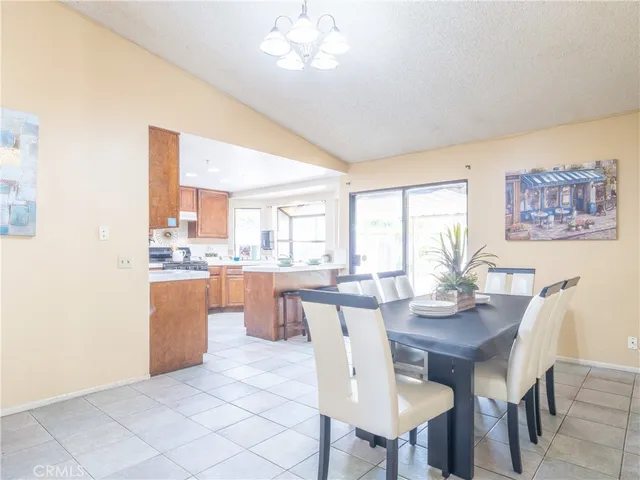 a dining room with granite countertop wooden floor and stainless steel appliances