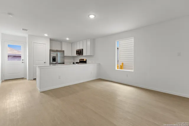 a view of a kitchen with a sink cabinets and a window