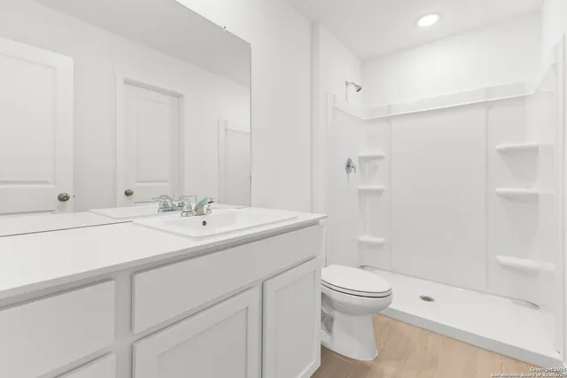 a bathroom with a sink toilet and shower