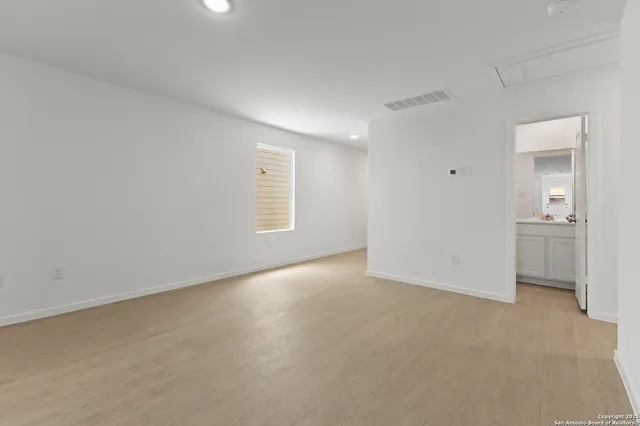 an empty room with windows and entrance