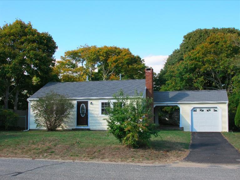 12 Iyanough Road Hyannis, MA 02601 - Photo 19 of 35 a view of a house with a yard and a garage