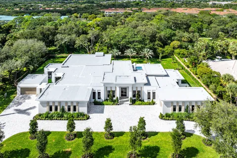 an aerial view of residential house with outdoor space and parking