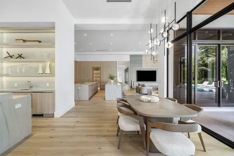 a large white kitchen with a large window