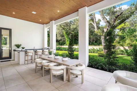 a living room with furniture a flat screen tv and a large window