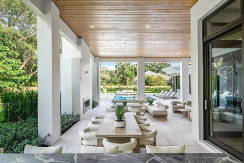 a living room with furniture large window and flat screen tv