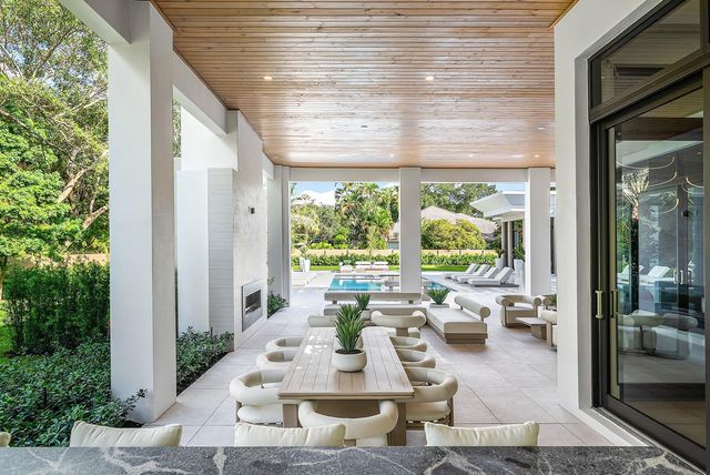 a living room with furniture large window and flat screen tv