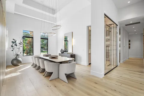 a bedroom with a large bed and a chandelier