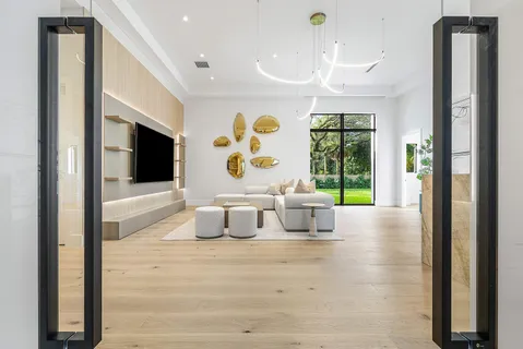 a bedroom with a large bed and a potted plant