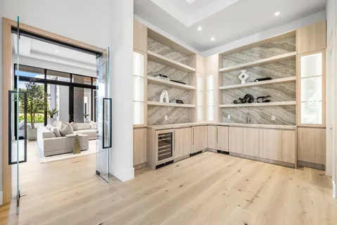 a front view of house with yard and trees in the background