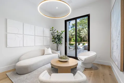 a front view of a house with patio swimming pool and outdoor seating