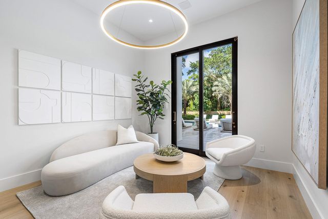 a front view of a house with patio swimming pool and outdoor seating